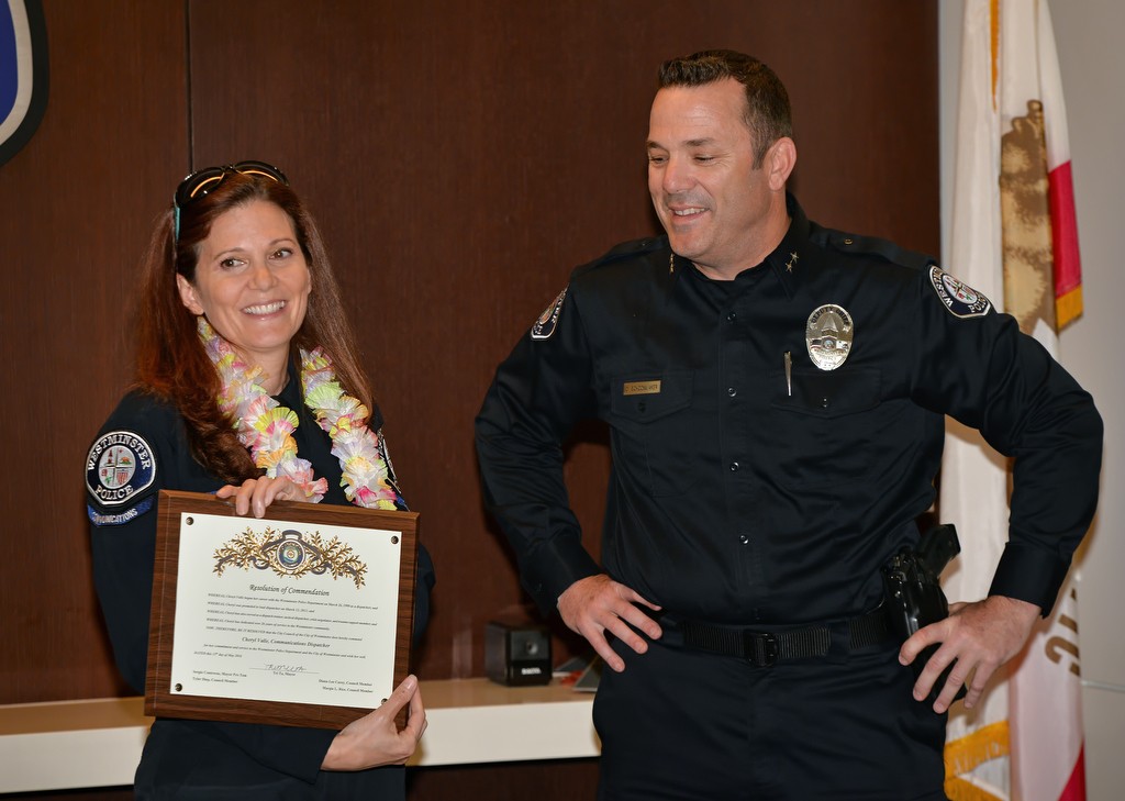 Westminster Acting Chief Dan Schoonmaker, right, presents Dispatcher Cheryl Valle with a commendation during her retirement ceremony. Photo by Steven Georges/Behind the Badge OC