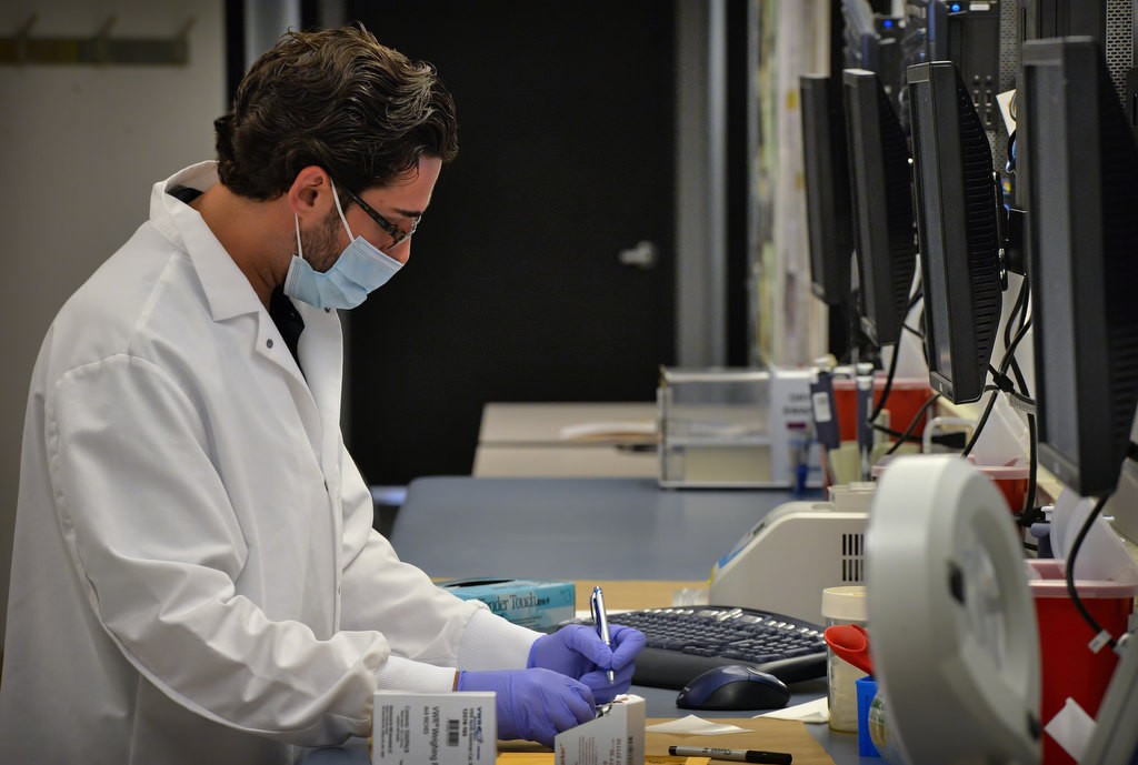 Sean Kapp, a forensic scientist with the OC Sheriff department, works with DNA evidence on property crimes, that includes stolen vehicles and burglary, at the OC Sheriff DepartmentÕs Crime Lab. Photo by Steven Georges/Behind the Badge OC