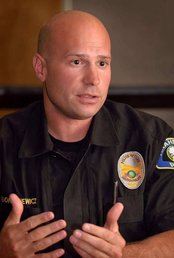 Anaheim PD Officer Brian Bonczkiewicz talks about how he and his K-9 partner Ivan, as part of an Anaheim PD SWAT team, helped detained the suspect on May 5, 2016, from a freeway chase that was responsible for the closure of the 91 freeway for hours in both directions in Anaheim Hills. Photo by Steven Georges/Behind the Badge OC