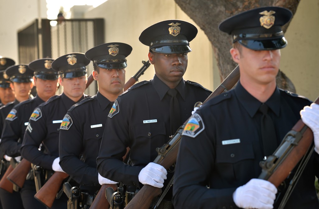 Tustin Police officers, including from right, Joseph Cossack, Robert Nelson and Mike Carter, arrive for the Wally Karp memorial ceremony at the Tustin PD. Photo by Steven Georges/Behind the Badge OC