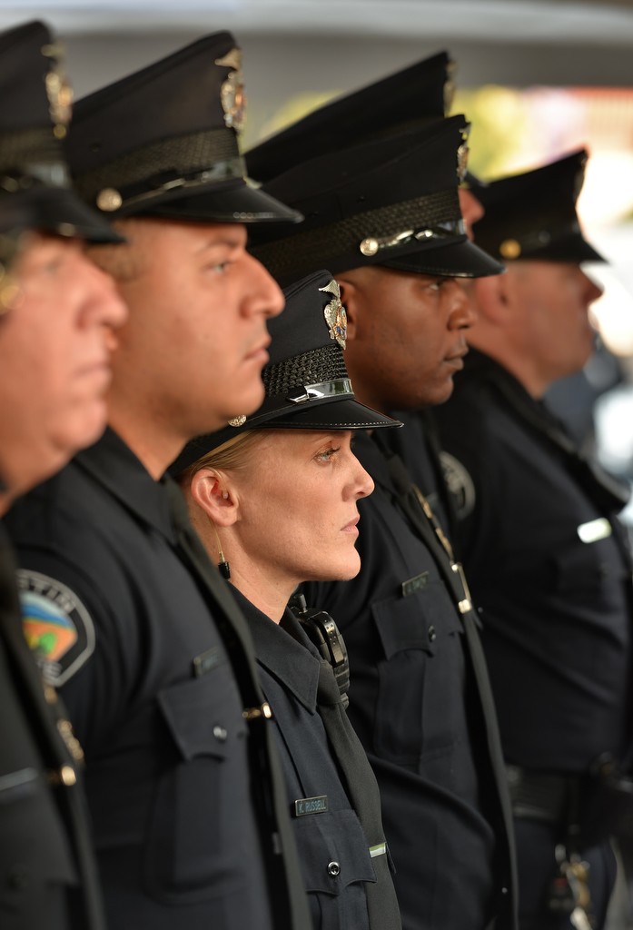 Tustin PD officers, including K. Russell, center, stand at attention the Wally Karp memorial ceremony. Photo by Steven Georges/Behind the Badge OC