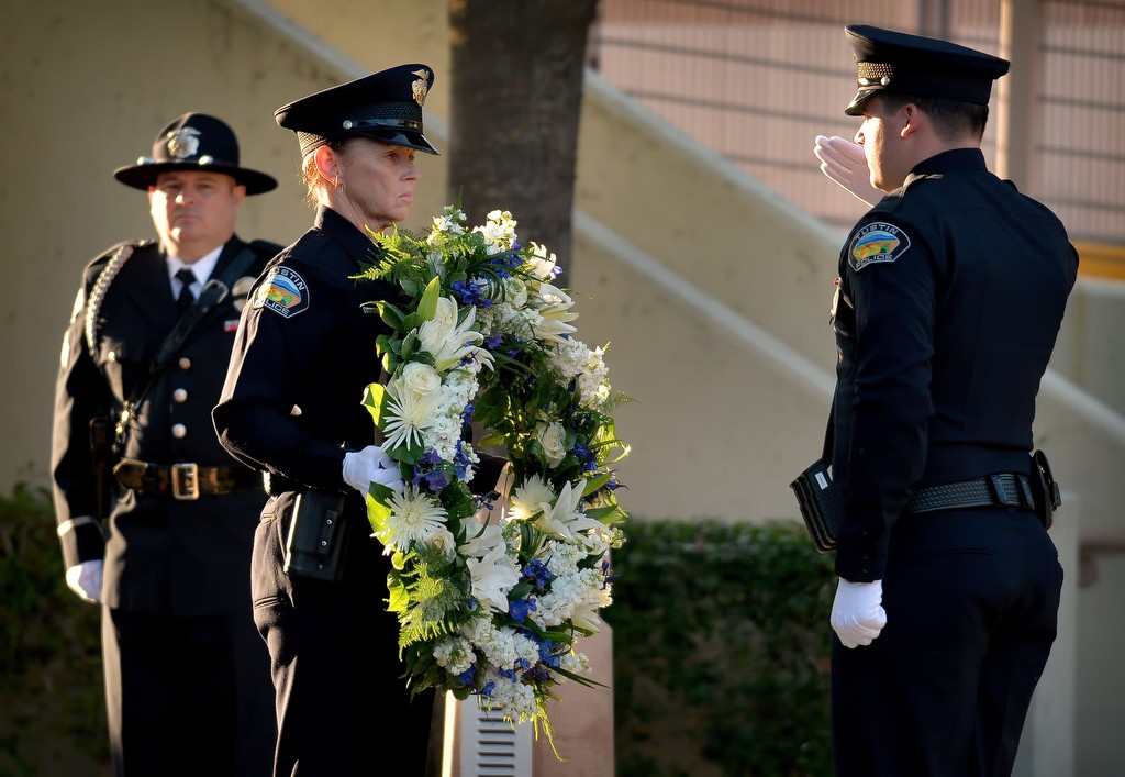 Tustin Police officers Pam Hardacre, left, and Taylor Ryan prepare to place a wreath at the base of Tustin PD’s memorial statue during the Wally Karp memorial ceremony. Photo by Steven Georges/Behind the Badge OC