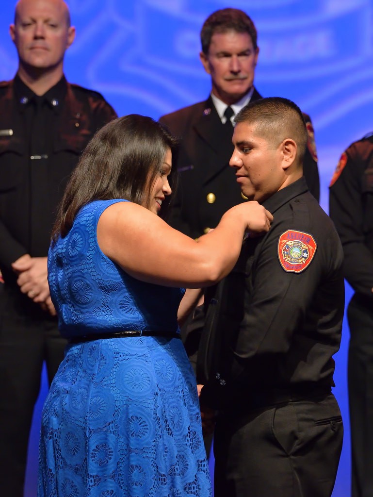 AF&R’s Captain Richard Martinez has his new badge pinned to him by his wife Priscella Martinez. Photo by Steven Georges/Behind the Badge OC
