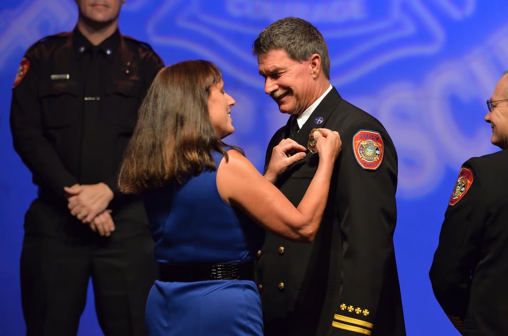 AF&R Deputy Fire Marshal Allen Hogue has his new badge pinned to him by his wife Nina. Photo by Steven Georges/Behind the Badge OC