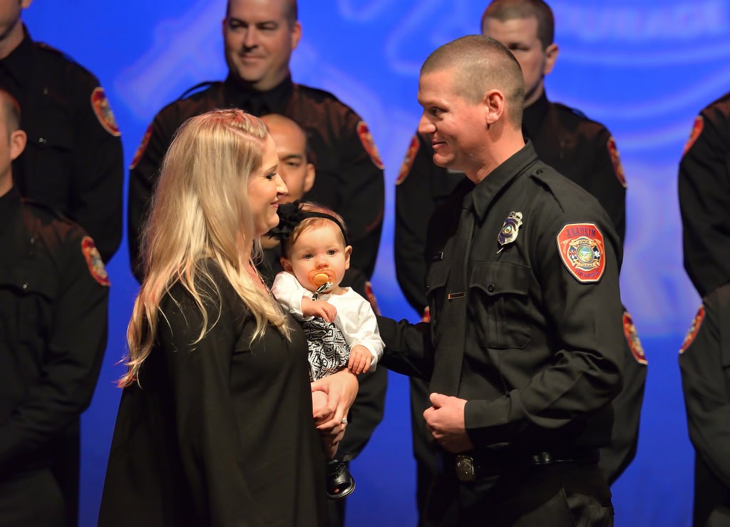 AF&R Firefighter Ian Maxwell gets his new badge from his wife Rachel Maxwell And His Daughter, Charlie. Photo by Steven Georges/Behind the Badge OC