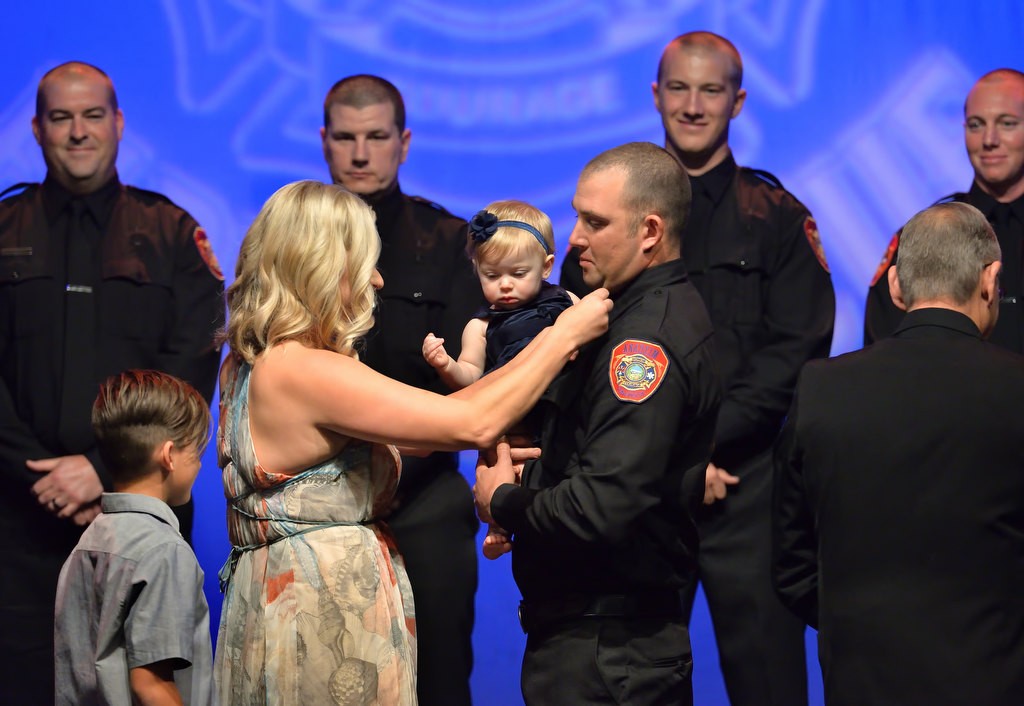 AF&R Firefighter David Panepinto his new badge pinned to him by his wife Christine, son Ryland and daughter Declyn. Photo by Steven Georges/Behind the Badge OC