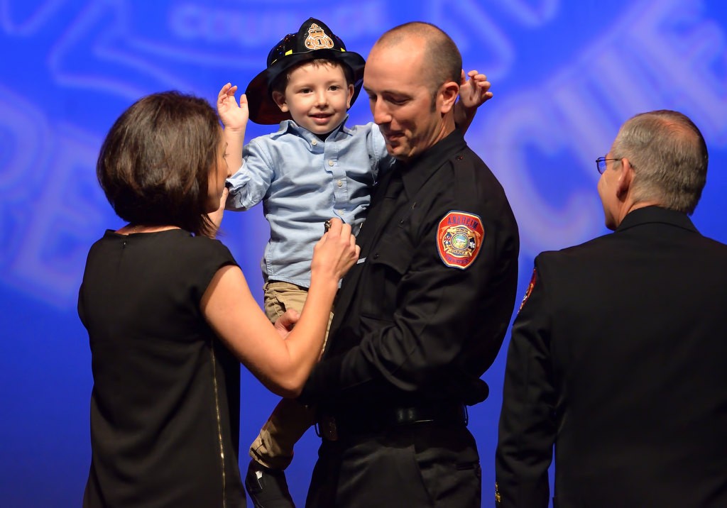 AF&R Firefighter Michael White has his new badge pinned to him by his wife, Amber, and Son Brayden. Photo by Steven Georges/Behind the Badge OC