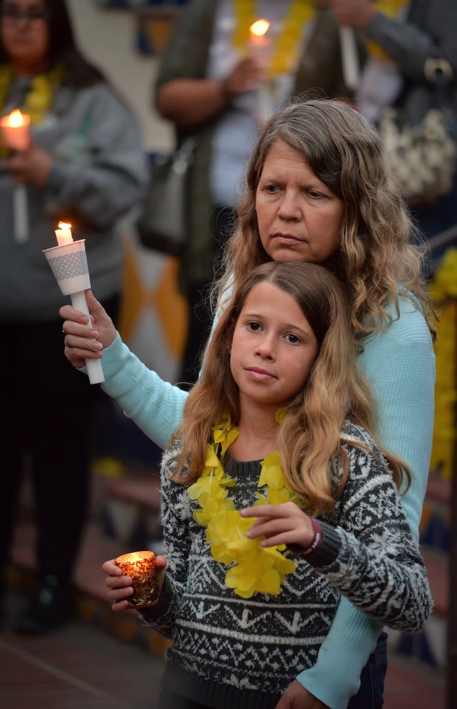 Laurie Rogers stands with her 10-year-old daughter Carly Rogers, during a candlelight vigil for Katherine King, who was diagnosed with an incurable brain stem tumor, at Fullerton PD’s headquarters. Katherine was too ill to attend but was able to watch the event from her home using a live internet feed. Photo by Steven Georges/Behind the Badge OC
