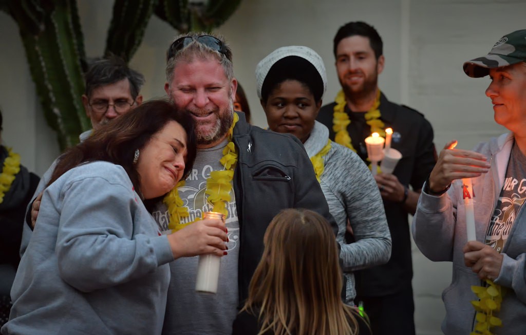 David King, father of Katherine King, who was diagnosed with an incurable brain stem tumor, gets a hug from Tina Hermosillo during a candlelight vigil for Katherine King at Fullerton PD’s headquarters. Photo by Steven Georges/Behind the Badge OC