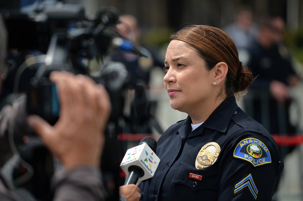 Detective Laura Lomeli of the Anaheim Police Department talks to Spanish media outside the Anaheim Convention Center as people protest presidential candidate Donald Trump was holding a rally inside. Photo by Steven Georges/Behind the Badge OC