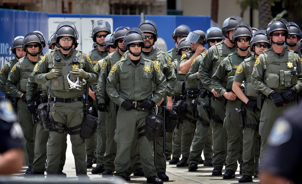 Orange County Sherif Deputies in riot gear stand by in outside the Anaheim Convention Center during a Donald Trump rally protest. Photo by Steven Georges/Behind the Badge OC