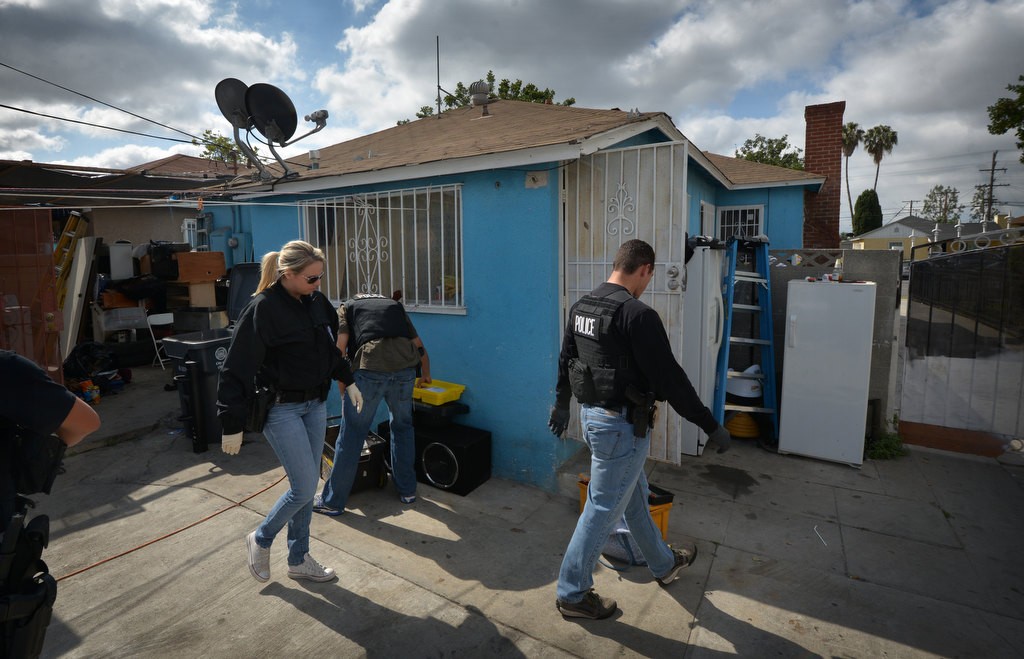 Garden Grove PD Officers and LA County Sheriff Deputies serve a warrant on a house on Palmer St. in Compton in connection to the burglars who ripped the doors off a liquor store in Garden Grove last Monday to steal several thousand California State Lottery “Scratchers” tickets. Photo by Steven Georges/Behind the Badge OC