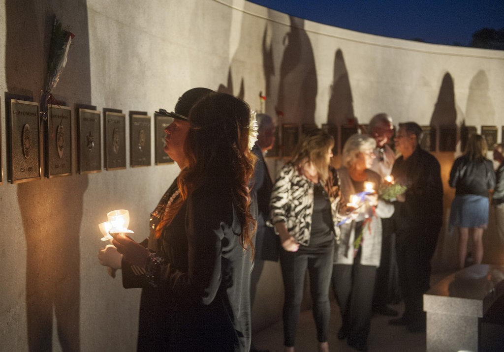 Friends and family of fallen peace officers pay their respects at the conclusion of the 2016 Orange County Peace Officers' Memorial Ceremony and Candlelight Vigil held at the OCSD Regional Training Facility.