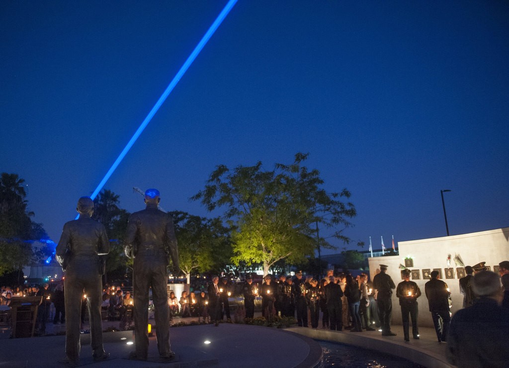Friends and family of fallen peace officers pay their respects at the conclusion of the 2016 Orange County Peace Officers' Memorial Ceremony and Candlelight Vigil held at the OCSD Regional Training Facility.