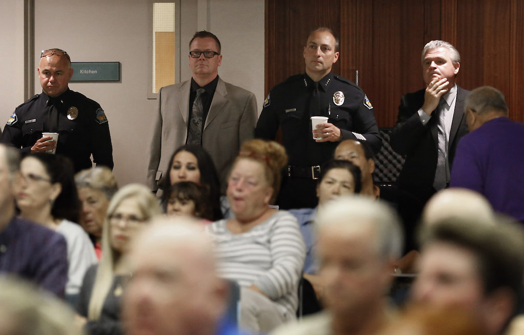 From left: Lt. Jeff Blair, Lt. John Strain, Chief Charles Celano and Capt. Paul Garaven of the Tustin Police Department listen as deputies from the Orange County Sheriff's Department give a presentation on possible terrorism-related cases that happened in Orange County. The OCSD presentation was part of Tustin's bi-annual Block Captain Community Watch meeting. Photo by Christine Cotter/Behind the Badge OC. 