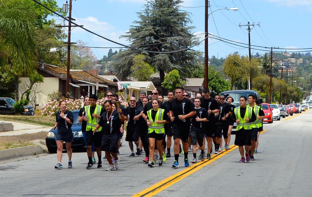 La Habra police personnel run with athletes from the Special Olympics in the annual torch relay that winds through Southern California Streets. Photo courtesy La Habra PD. 
