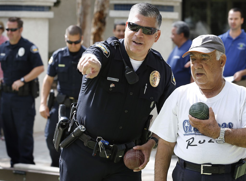 Tustin's PD's Officer Val Villarreal and Vince Zoida in a bocce ball competition at the Tustin Senior Center.  Photo by Christine Cotter/Behind the Badge OC 