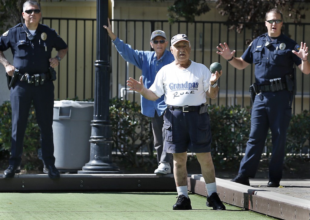 Tustin's PD's Officer Val Villarreal and Officer Jeremy Laurich team up with Vince Zoida, front, and other members of the Tustin Senior Center for a bocce ball competition.  Photo by Christine Cotter/Behind the Badge OC 