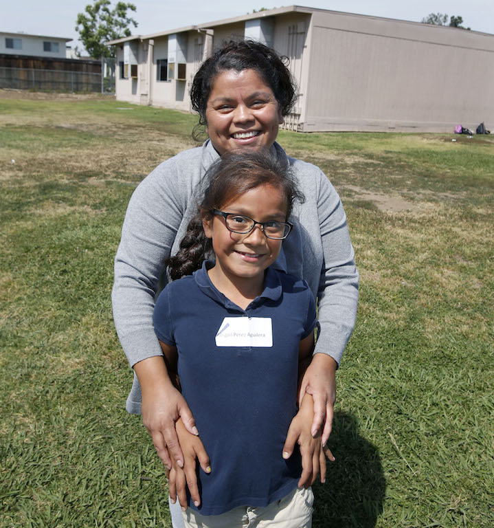 Heideman Elementary school student Abgail Perez with her mom during the Tustin Police Department's community outreach run program at the school.  Photo by Christine Cotter/Behind the Badge OC 