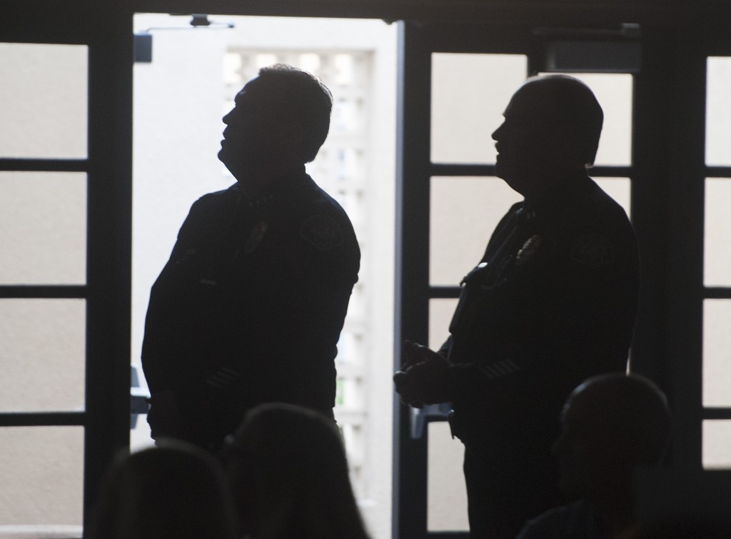 La Habra Police Chief Jerry Price, left, and Captain Jeff Swaim watch a slideshow during the department's 2016 Awards ceremony. Photo by Miguel Vasconcellos/Behind the Badge OC 