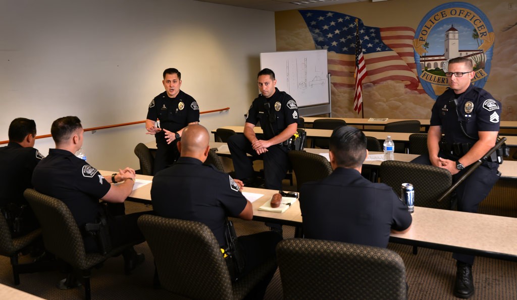 Fullerton PD Lt. Thomas Oliveras, left, Sgt. Pedram Gharah and Sgt. Jon Radus conduct a Field Training Officer meeting at police headquarters. Photo by Steven Georges/Behind the Badge OC