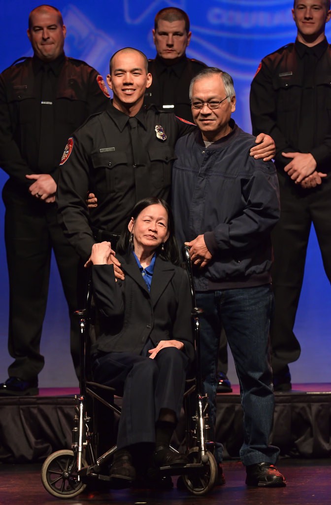 AF&R Firefighter Vinh Nguyen with his father, Chien Nguyen, and mother, Namtein Tran, after receiving his new badge. Photo by Steven Georges/Behind the Badge OC