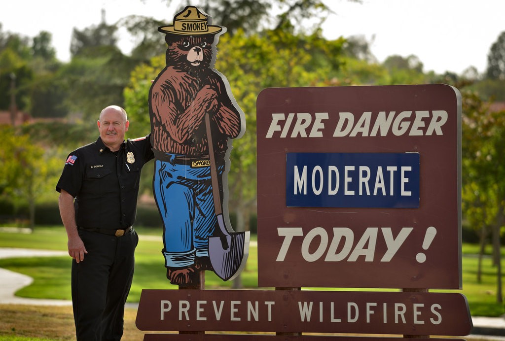 Anaheim Fire & Rescue Deputy Chief Rusty Coffelt with Smokey Bear at Anaheim Fire Station #10. Photo by Steven Georges/Behind the Badge OC