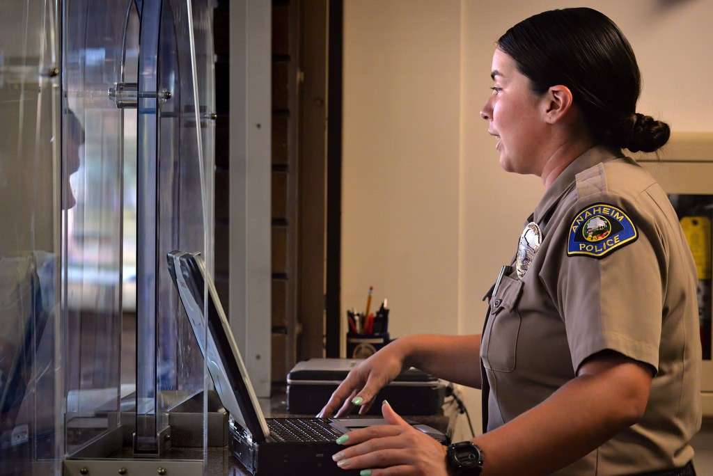 Anaheim PD Cadet Karina Munoz helps people at the front desk of the Harbor Blvd. police headquarters. Photo by Steven Georges/Behind the Badge OC