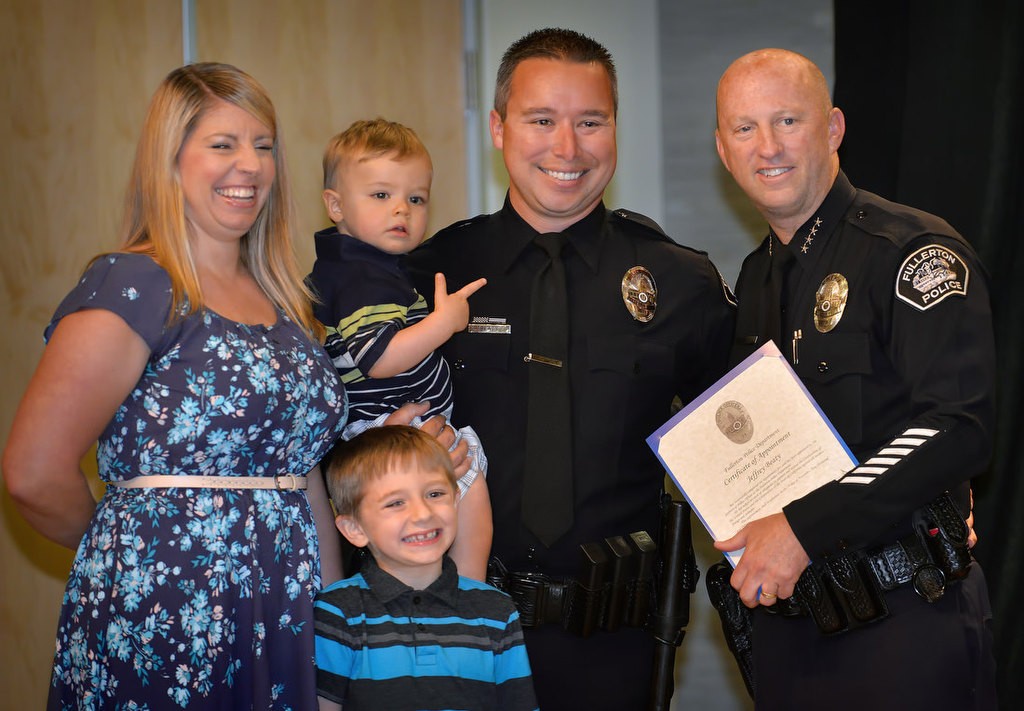 Jeffrey Beaty stands Chief Dan Hughes and with his family that includes his wife, Elizabeth, Step-Son Aaron and Son Zachary, as one of Fullerton’s new police officers. Photo by Steven Georges/Behind the Badge OC
