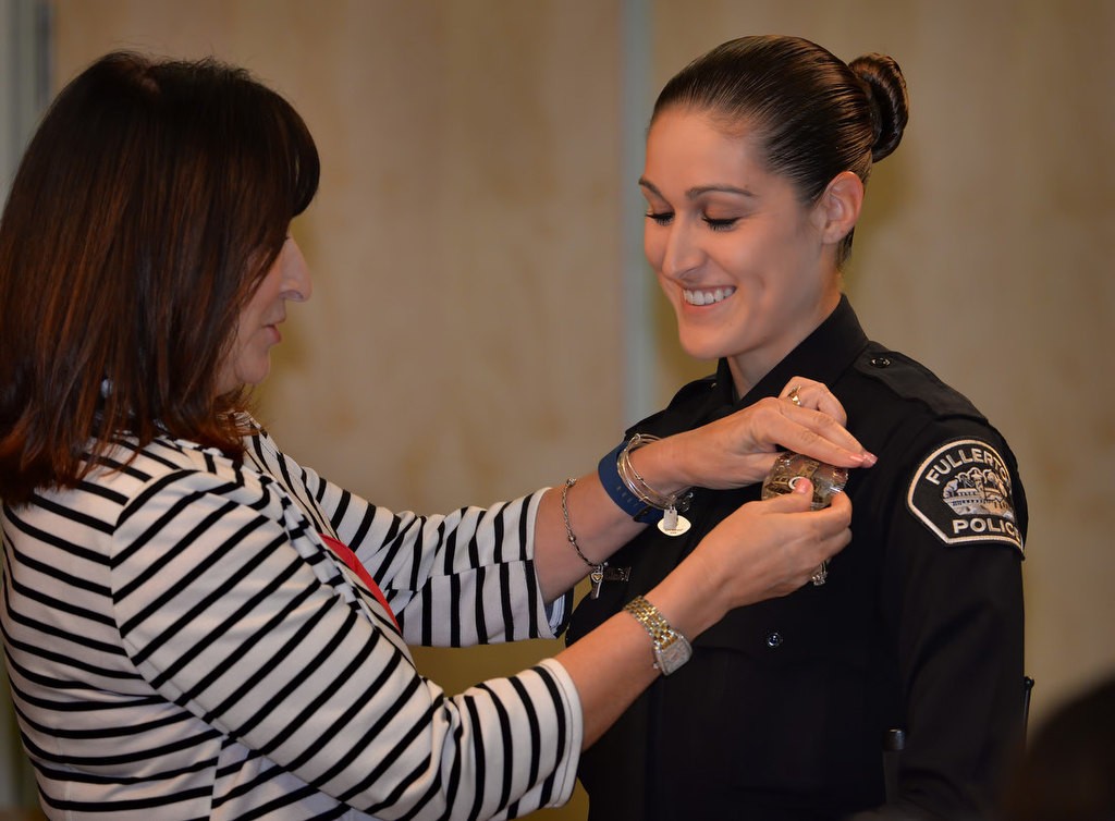 Fullerton’s new Police Officer Victoria Thayer receives her new badge from her mother Susan. Photo by Steven Georges/Behind the Badge OC