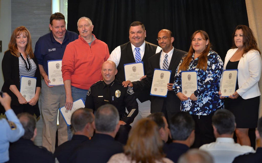 Fullerton Police Chief Dan Hughes, center, presents the newest members of the Chief’s Advisory Board with certificates of appreciation during a ceremony in Fullerton. They include Gretchen Cox, left, Doug Bowen, Greg Bock, (Chief Dan Hughes) Dallas Stout, Omar Siddiqui, Egleth Nuncci and Ilse Miranda. Photo by Steven Georges/Behind the Badge OC