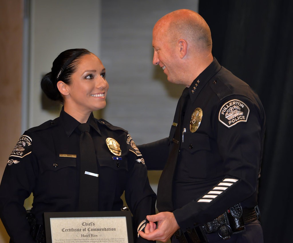 Fullerton PD Officer Hazel Rios receives the Chief’s Certificate of Commendation from Chief Dan Hughes for her volunteering to help save a child’s life by being a bone marrow donor. Photo by Steven Georges/Behind the Badge OC