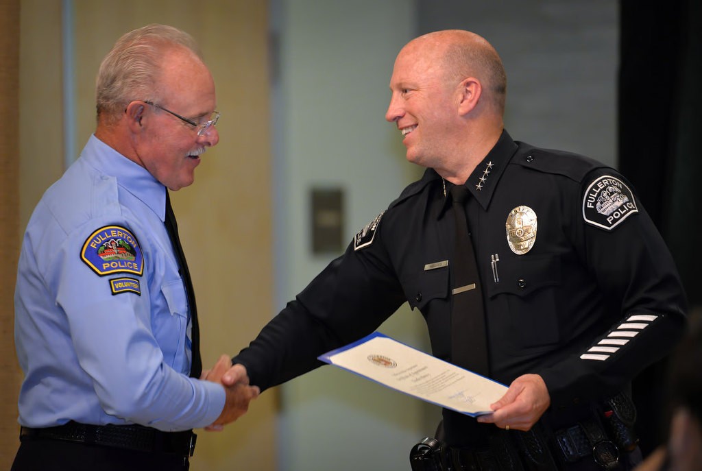 Charles Pierecy is congratulated by Chief Dan Hughes as he is recognized for joining the FPD RSVP program. Photo by Steven Georges/Behind the Badge OC