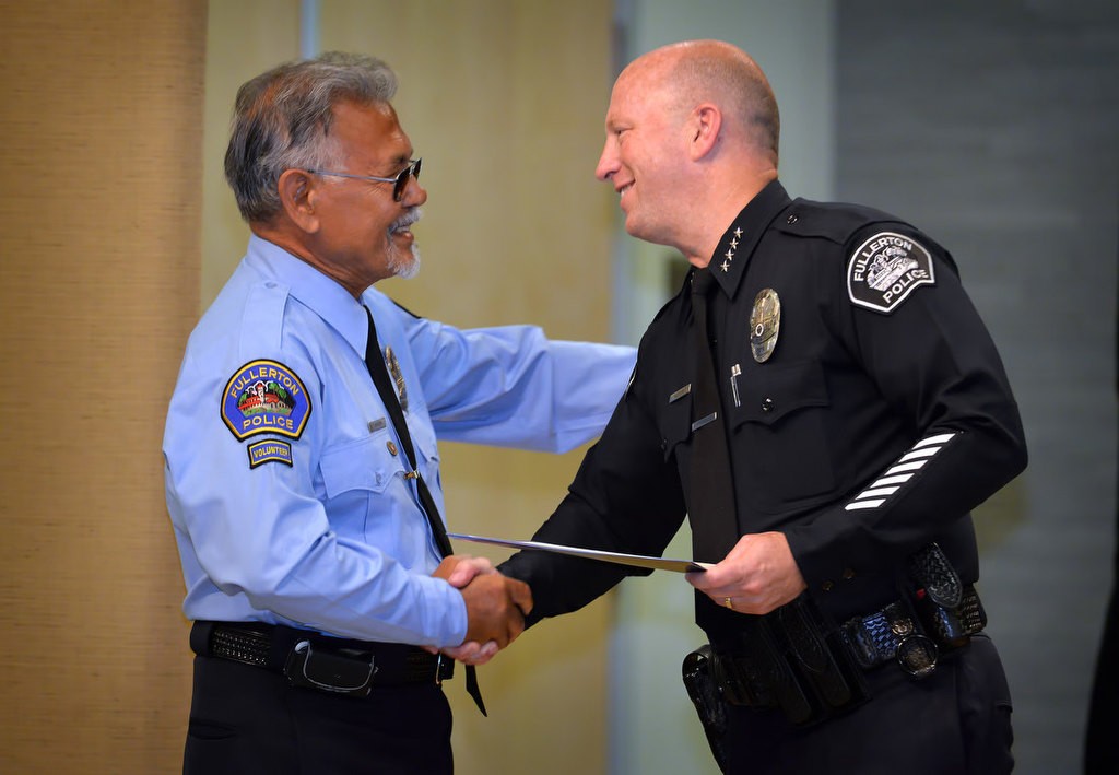Robert Drissen is congratulated by Chief Dan Hughes as he is recognized for joining the FPD RSVP program. Photo by Steven Georges/Behind the Badge OC