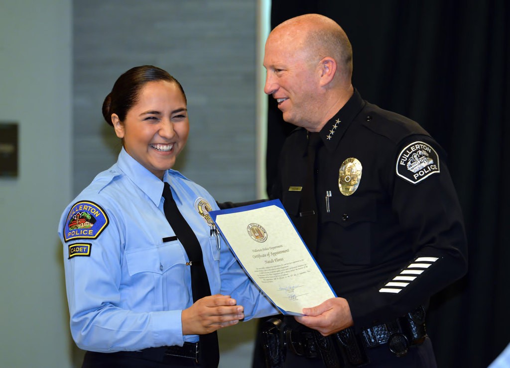 Natali Flores is congratulated by Chief Dan Hughes as she is recognized for joining the FPD Cadet program. Photo by Steven Georges/Behind the Badge OC