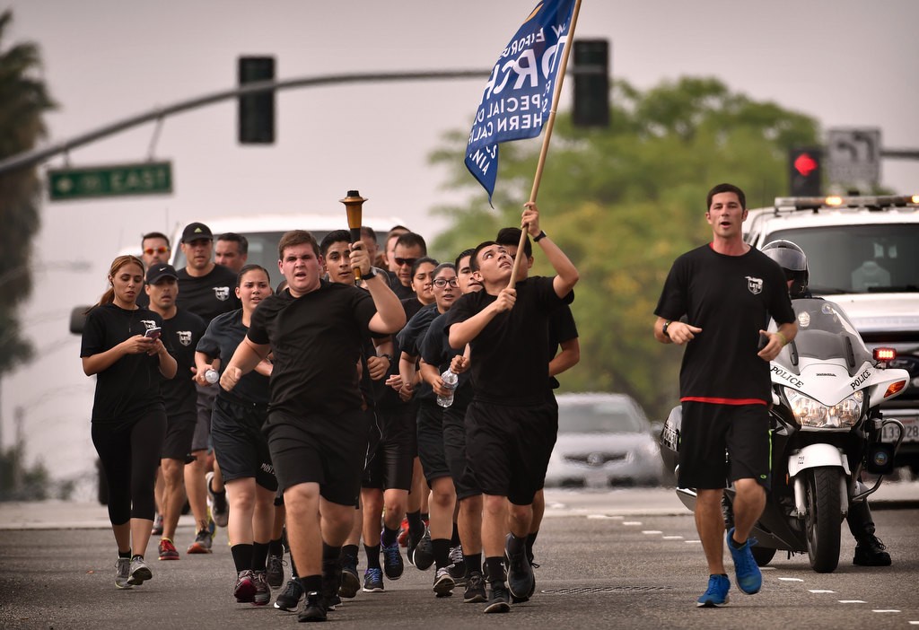 Anaheim Police Explorers from Post 249, Anaheim PD officers and Special Olympians run up Harbor Blvd. during the Law Enforcement Torch Run for Special Olympics of Southern California. Photo by Steven Georges/Behind the Badge OC