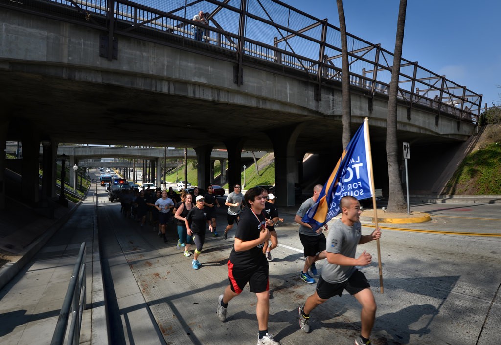 Members of the Fullerton PD and Special Olympians run up Harbor Blvd. before Santa Fe Ave. during the Law Enforcement Torch Run for Special Olympics of Southern California. Photo by Steven Georges/Behind the Badge OC