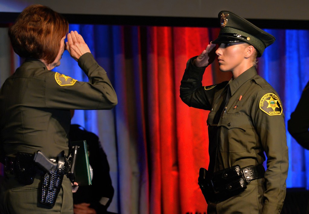 OCSD Deputy Dallas Mihalik, right, salutes Orange County Sheriff Sandra Hutchens during the Orange County Sheriff's Regional Training Academy's graduation ceremony. Photo by Steven Georges/Behind the Badge OC