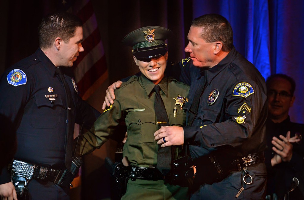 OCSD Deputy Dallas Mihalik gets a hug from her brother, Garden Grove PD Officer Danny Mihalik, left, and her father, Anaheim PD Motor Officer Danny Mihalik, after receiving her new badge during graduation ceremonies. Photo by Steven Georges/Behind the Badge OC