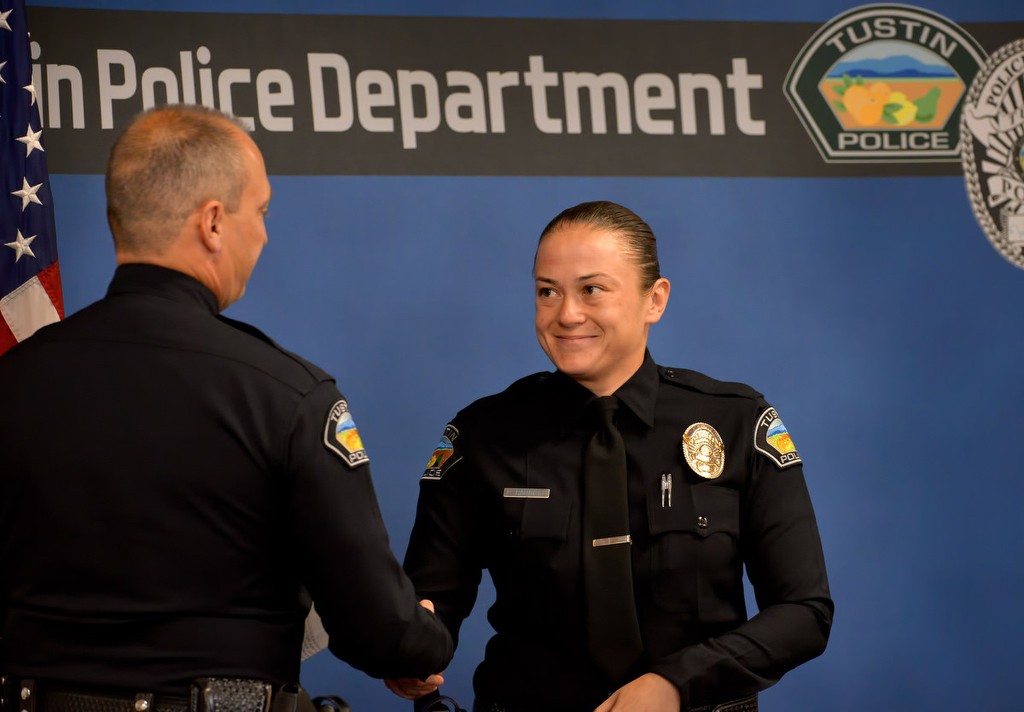 Tustin PD's new officer, Leah Barrett, is congratulated by Tustin Police Chief Charles Celano during a small Tustin PD ceremony after the Orange County Sheriff's Regional Training Academy graduation ceremony. Photo by Steven Georges/Behind the Badge OC