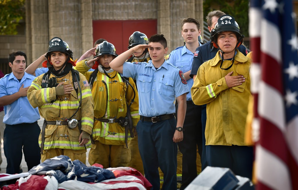 Anaheim Fire & Rescue cadets show their respect during the Pledge of Allegiance at the start of a flag burning ceremony to properly dispose of nearly 2,500 American flags at the North Net Fire Training Center in Anaheim. Photo by Steven Georges/Behind the Badge OC
