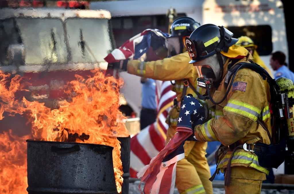Anaheim Fire & Rescue cadets dispose nearly 2.500 American flags according to tradition during a flag burning ceremony at the North Net Fire Training Center in Anaheim. Photo by Steven Georges/Behind the Badge OC