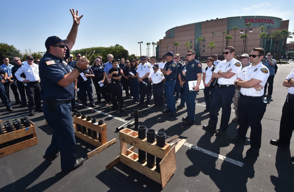 Orange County Fire Authority Engineerz Scott Lake talks to firefighters from all over about different types of outdoor aerial fireworks, what can go wrong and what to look for as a fire inspector during a pyro training session at the Honda Center. Photo by Steven Georges/Behind the Badge OC