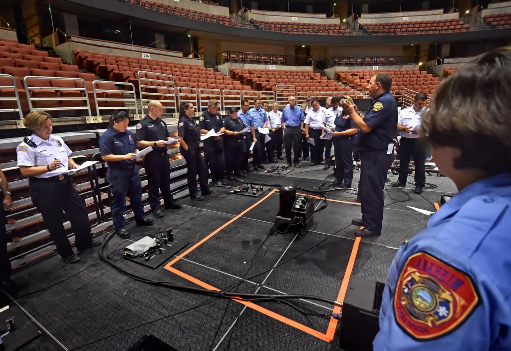 Orange County Fire Authority Engineer Scott Lake talks to potential fire inspectors from various fire agencies about the various types of indoor theatrical fireworks and other types of fire generators used on stage and what to look out for during a fire inspection, during an aerial/theatrical pyro training session put on by Anaheim Fire & Rescue at the Honda Center. Photo by Steven Georges/Behind the Badge OC