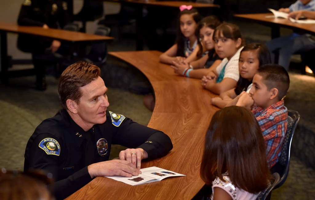 Anaheim Deputy Chief Julian Harvey talks to the kids receiving awards before the Do the Right Thing  ceremony at police headquarters. Photo by Steven Georges/Behind the Badge OC