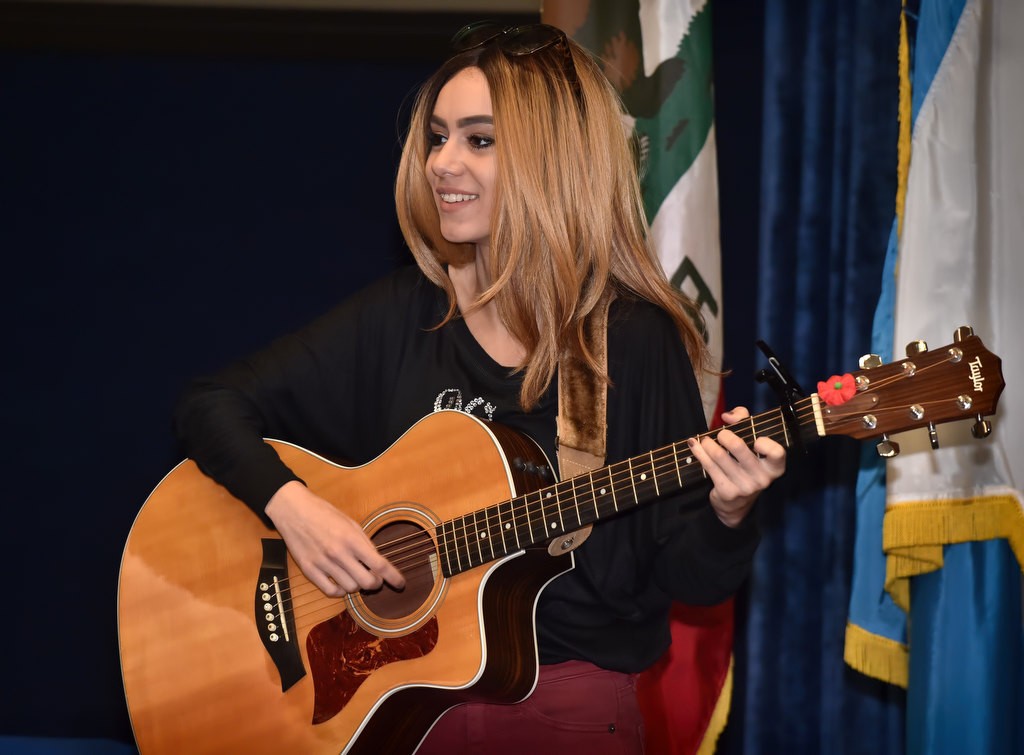 Aviella Winder, the person who helped bring the “Do The Right Thing” awards to Anaheim, sings God Bless America at the start of the Anaheim Police Department’s Do the Right Thing awards ceremony at the Anaheim police headquarters. Photo by Steven Georges/Behind the Badge OC
