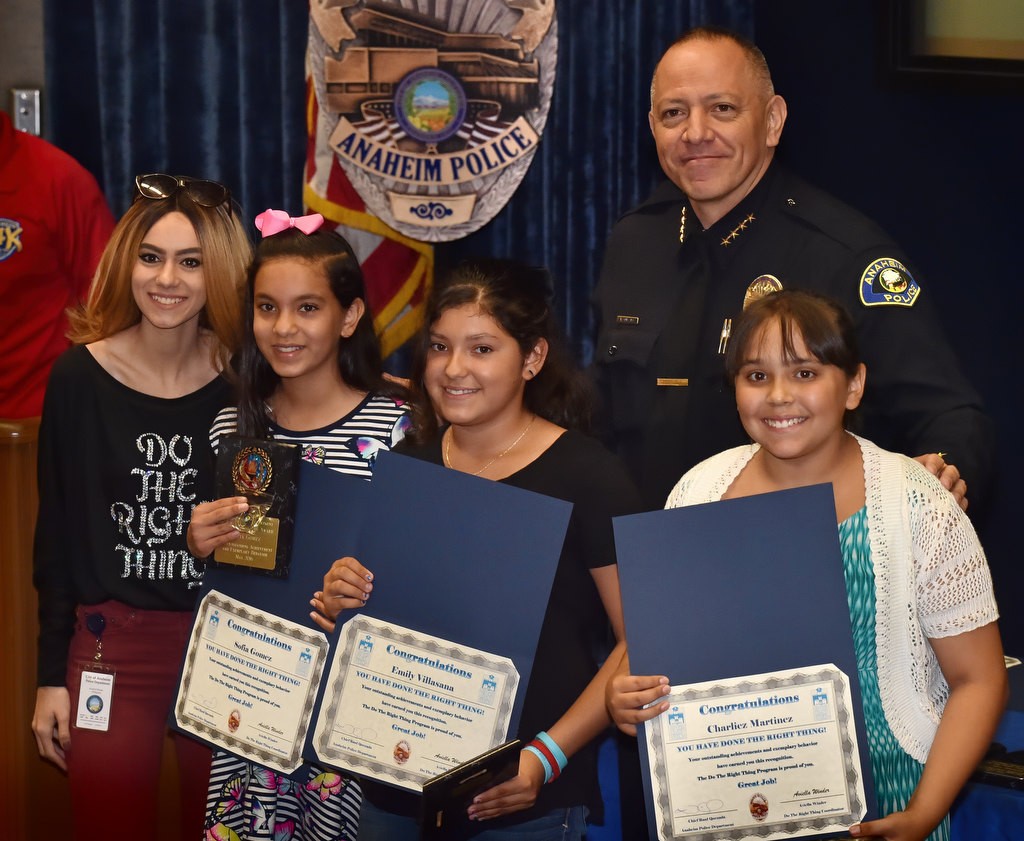 Sofia Gomez, left, Emily Villasana and Charliez Martinez, right, all from Stoddard Elementary, receive their Do the Right Thing award from Aviella Winder, left, and Anaheim Police Chief Raul Quezada. Valeria Lara, the forth girl to receive the group award, was not present. Photo by Steven Georges/Behind the Badge OC