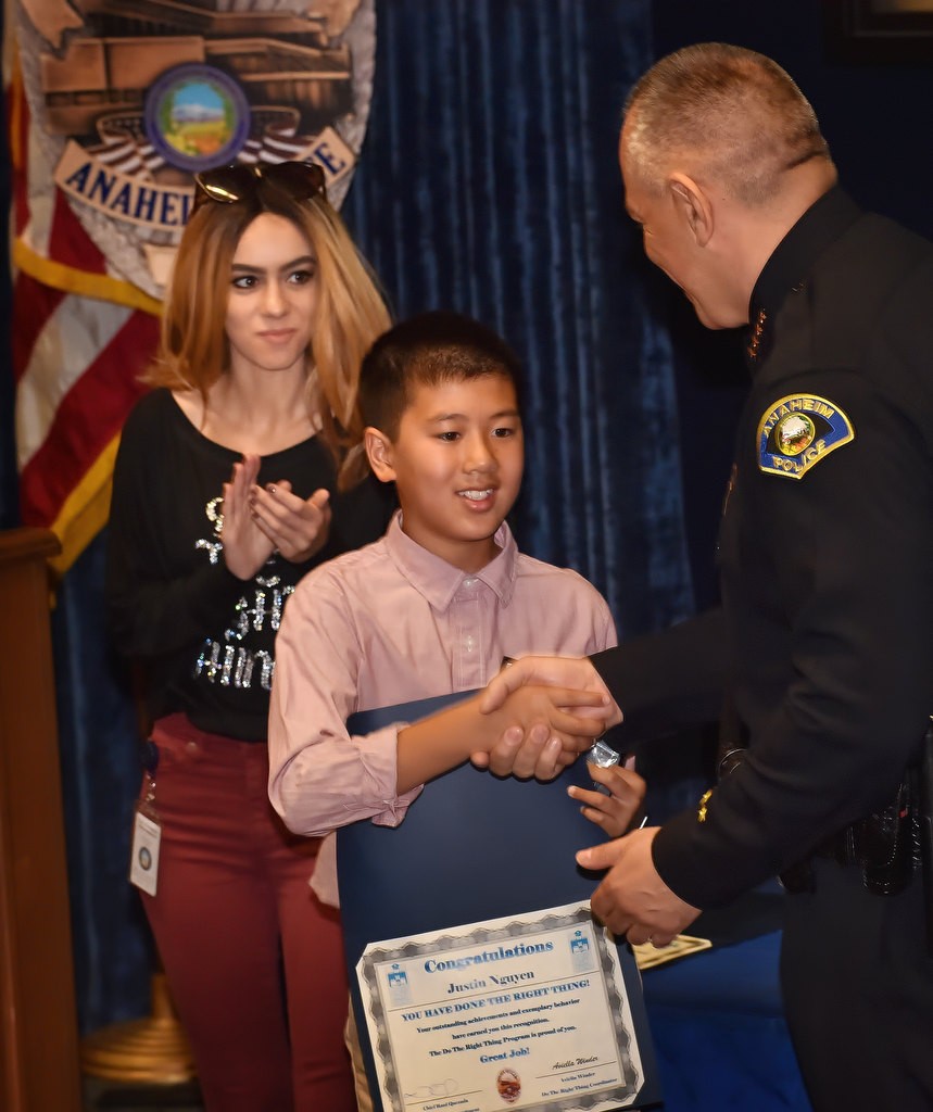 Justin Nguyen, sixth grade student from Betsy Ross Elementary School, receives his Do the Right Thing award from Anaheim Police Chief Raul Quezada and Aviella Winder, left. Photo by Steven Georges/Behind the Badge OC