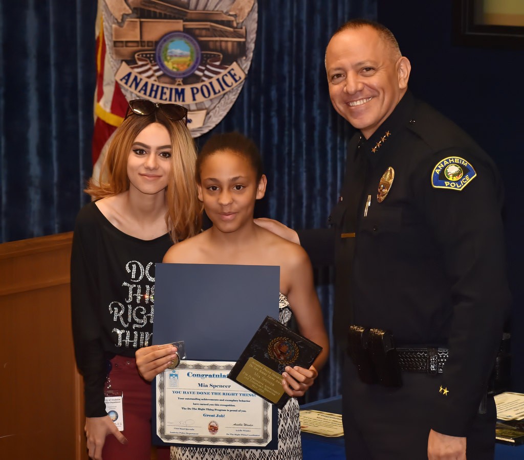 Mia Spencer, seventh grade student from Sycamore Jr. High School, receives her Do the Right Thing award from Aviella Winder, left, and Anaheim Police Chief Raul Quezada. Photo by Steven Georges/Behind the Badge OC