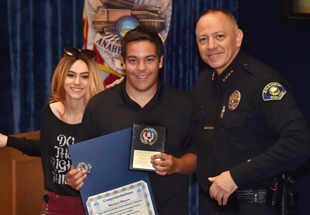Michael Blanco, eleventh grade student from Yorba Linda High School, receives his Do the Right Thing award from Aviella Winder, left, and Anaheim Police Chief Raul Quezada. Photo by Steven Georges/Behind the Badge OC